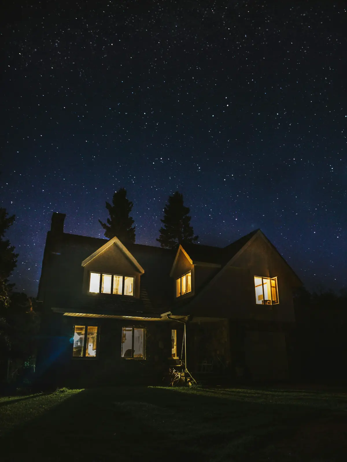 Home with warm lights glowing at night