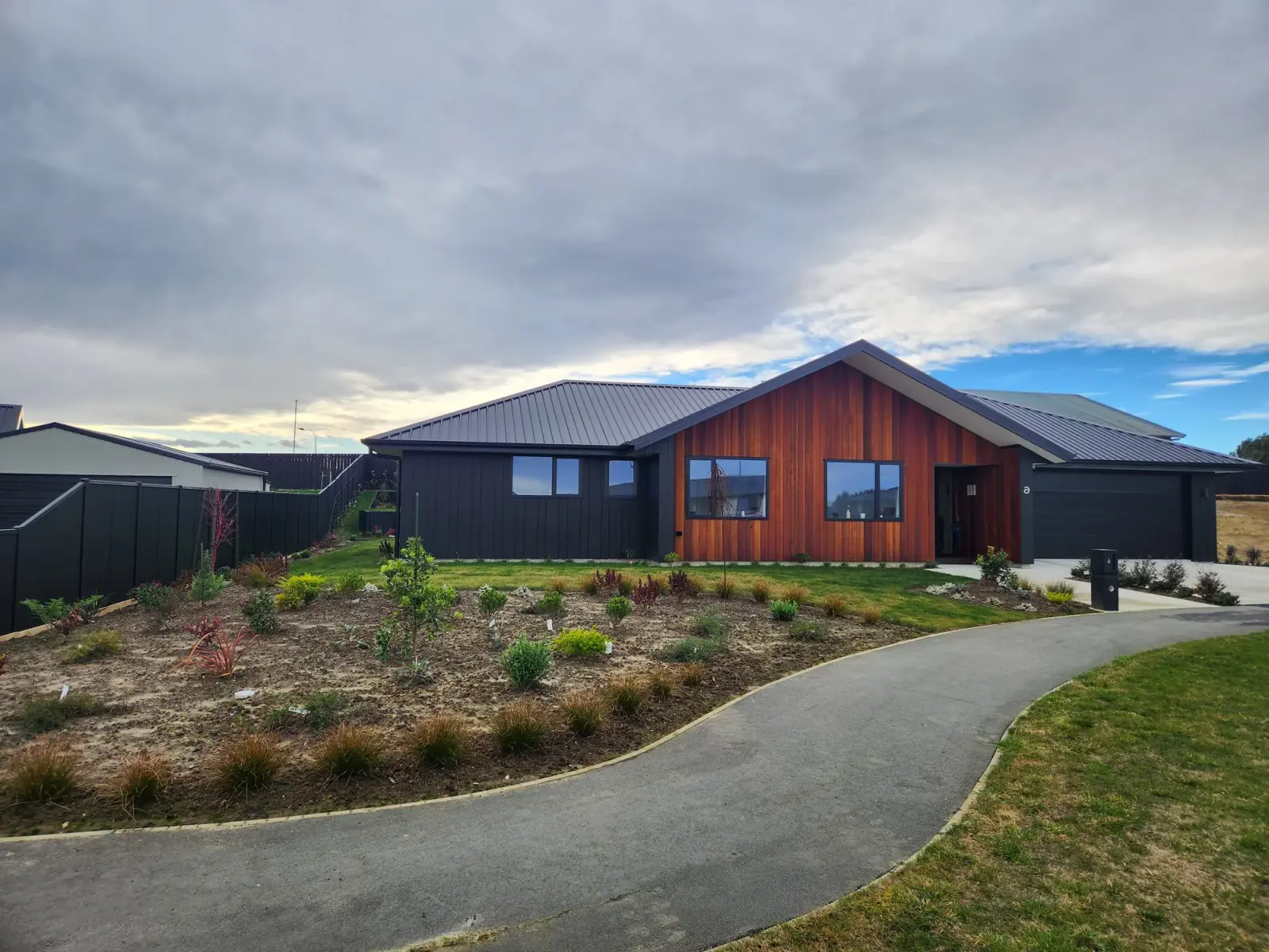Completed new home in Dunedin with cedar and charcoal cladding, wired by Serviceman