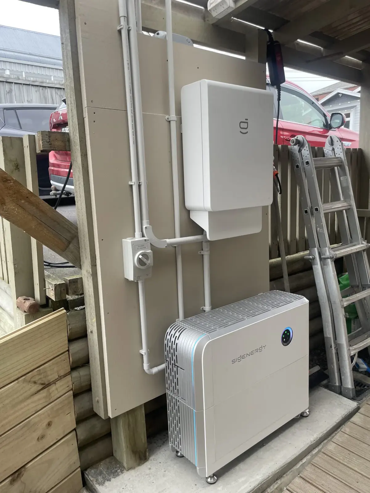 Sigenergy SigenStor inverter, isolators and labelled DC conduit installed by Serviceman in Dunedin